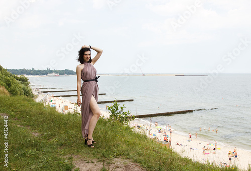 young woman standing by the sea
