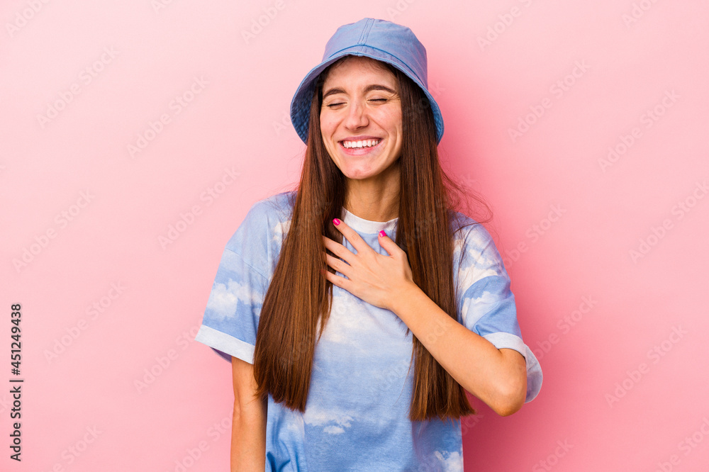 Young caucasian woman isolated on pink background laughs out loudly keeping hand on chest. Young caucasian woman isolated on pink background laughs out loudly keeping hand on chest.