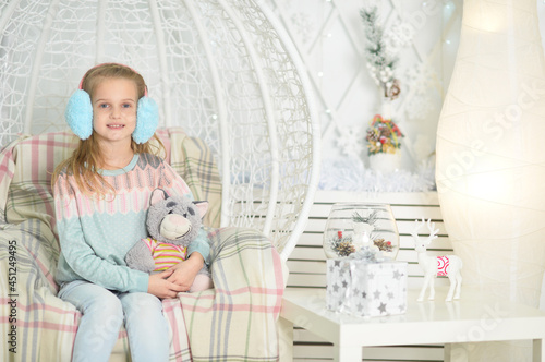 Portrait of cute emotional little girl posing on swing photo