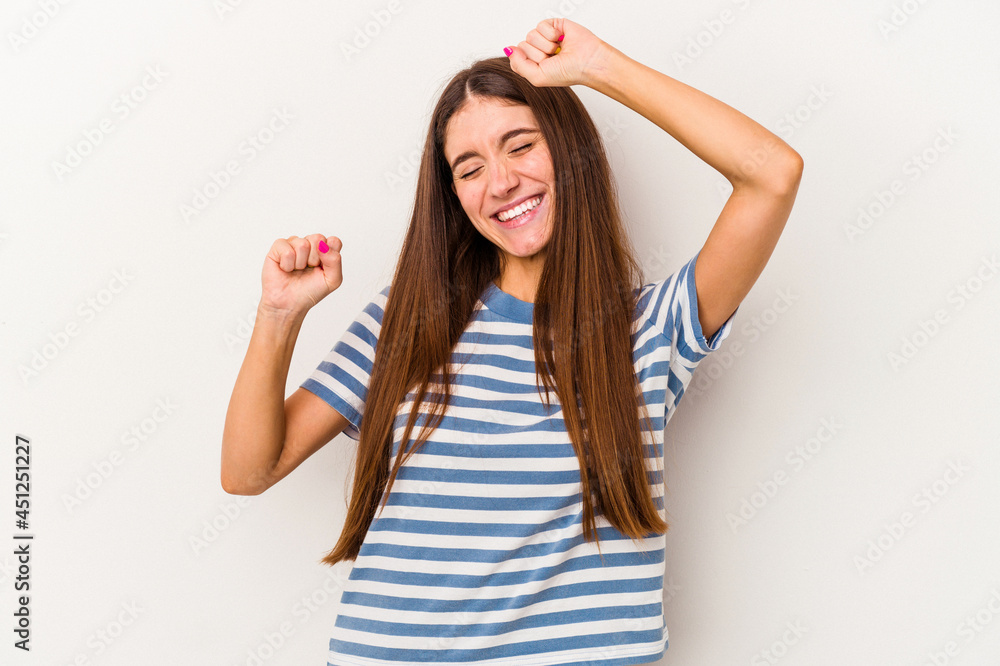 Young caucasian woman isolated on white background celebrating a special day, jumps and raise arms with energy. Young caucasian woman isolated on white background celebrating a special day, jumps and raise arms with energy.