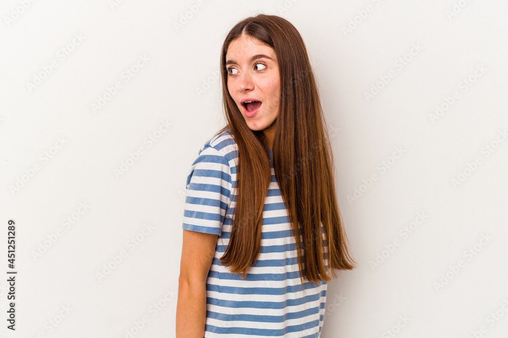 Young caucasian woman isolated on white background looks aside smiling, cheerful and pleasant. Young caucasian woman isolated on white background looks aside smiling, cheerful and pleasant.