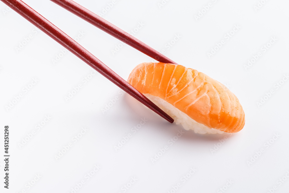 Sushi salmon with chopsticks isolated on white Sushi salmon with chopsticks isolated on white