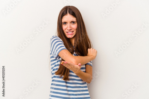 Young caucasian woman isolated on white background massaging elbow, suffering after a bad movement.
