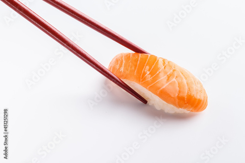 Sushi salmon with chopsticks isolated on white