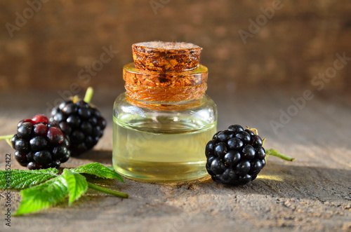Blackberry seed essential oil in a glass bottle for skin care, naturopathy and wellness.Rubus villosus extract.Selective focus. photo