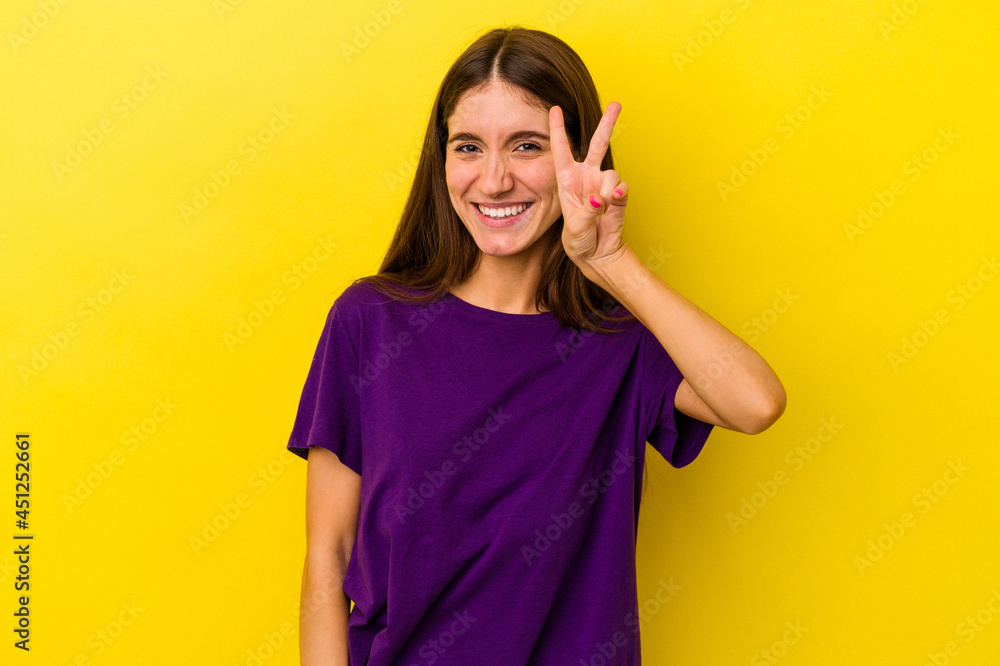 Young caucasian woman isolated on yellow background showing number two with fingers. Young caucasian woman isolated on yellow background showing number two with fingers.