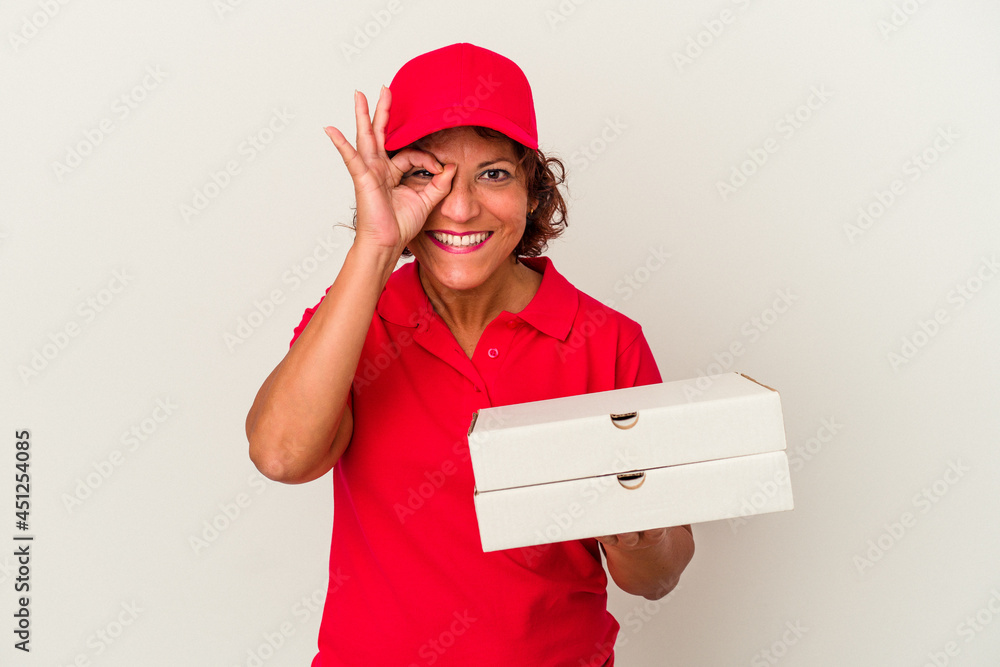 Middle age delivery woman taking pizzas isolated on white background excited keeping ok gesture on eye. Middle age delivery woman taking pizzas isolated on white background excited keeping ok gesture on eye.