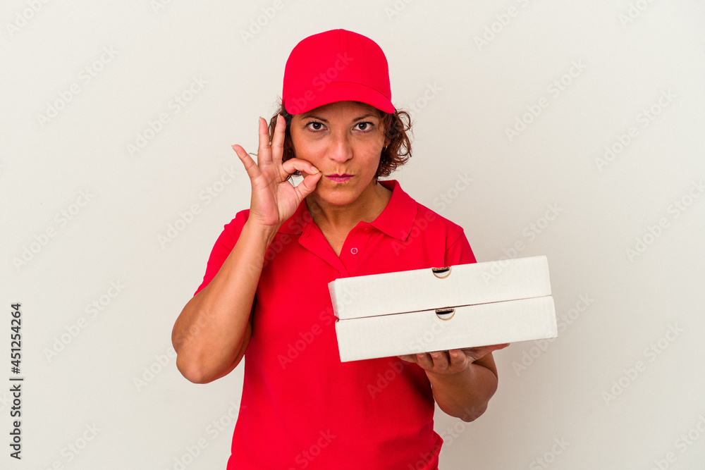 Middle age delivery woman taking pizzas isolated on white background with fingers on lips keeping a secret. Middle age delivery woman taking pizzas isolated on white background with fingers on lips keeping a secret.