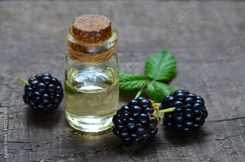 Blackberry seed essential oil in a glass bottle for skin care, naturopathy and wellness.Rubus villosus extract.Selective focus. photo