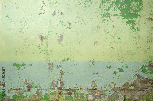 Old wall with green peeling paint