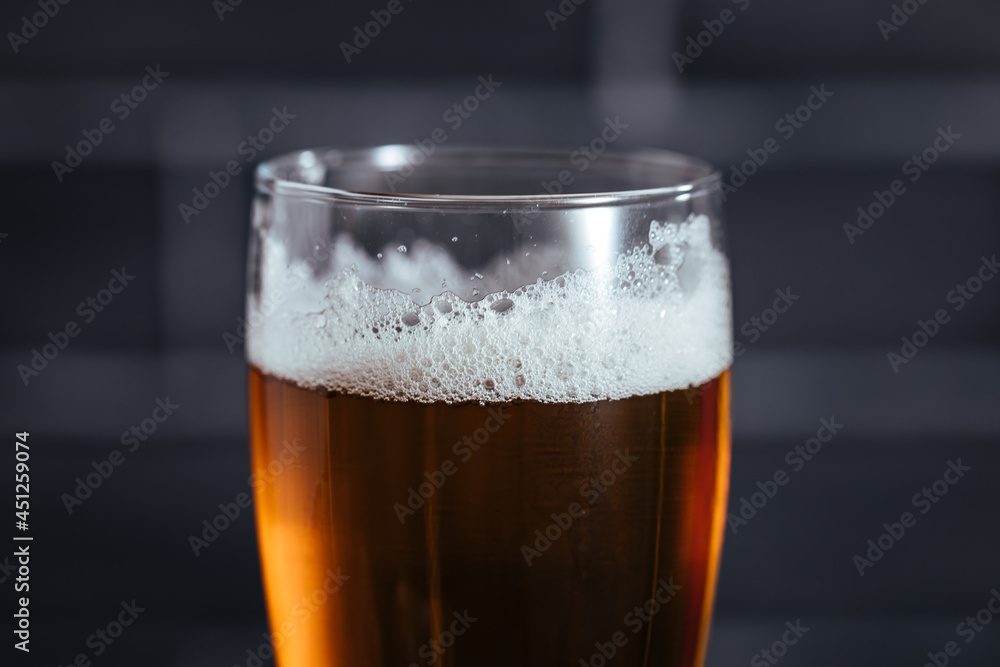 Close up of top of beer glass with foam Close up of top of beer glass with foam