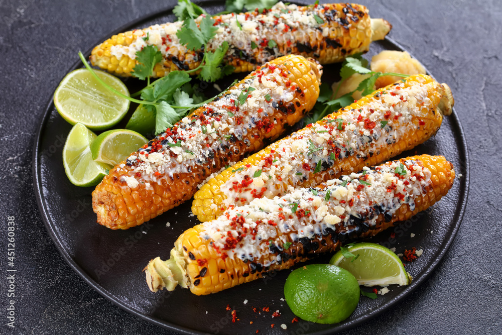 Elotes, Grilled Mexican Street Corn on a plate Elotes, Grilled Mexican Street Corn on a plate