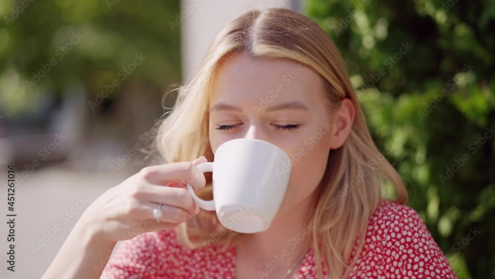 Young woman drinking coffee in summer Young woman drinking coffee in summer