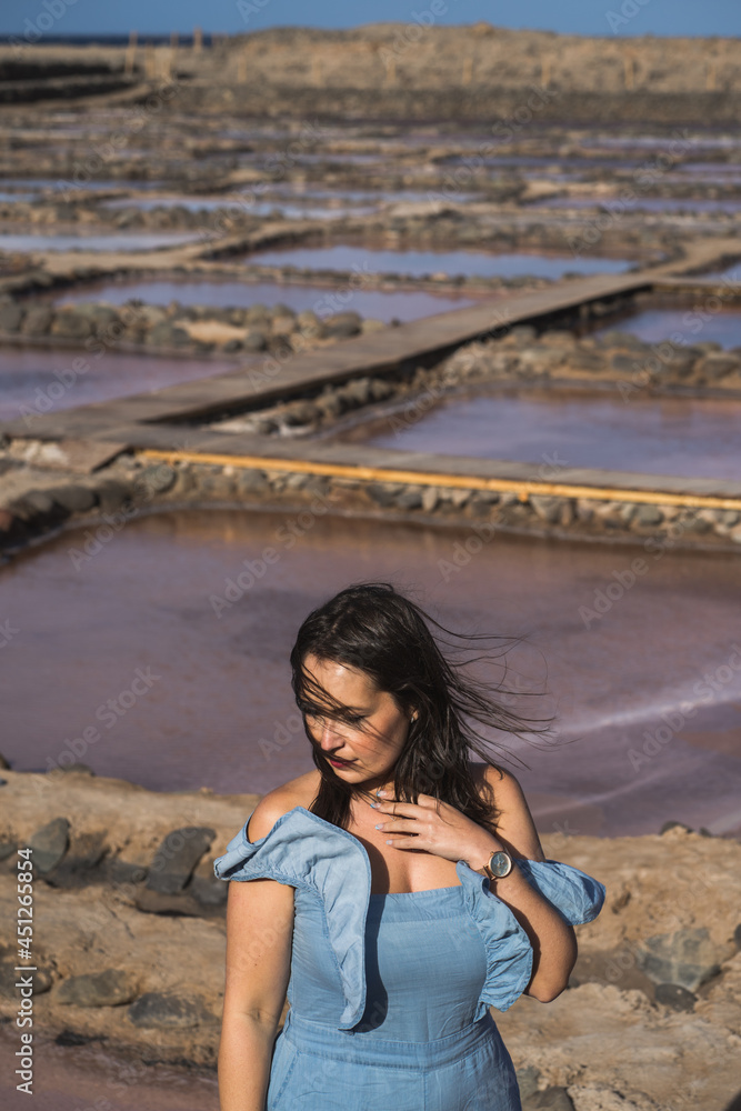 Beautiful woman breathing on violet saline lake