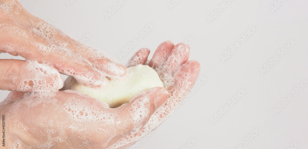 Hands washing gesture with bar soap and foam bubble on white background. Hands washing gesture with bar soap and foam bubble on white background.