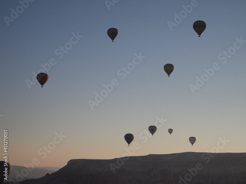 Various balloons flying in the sky and land