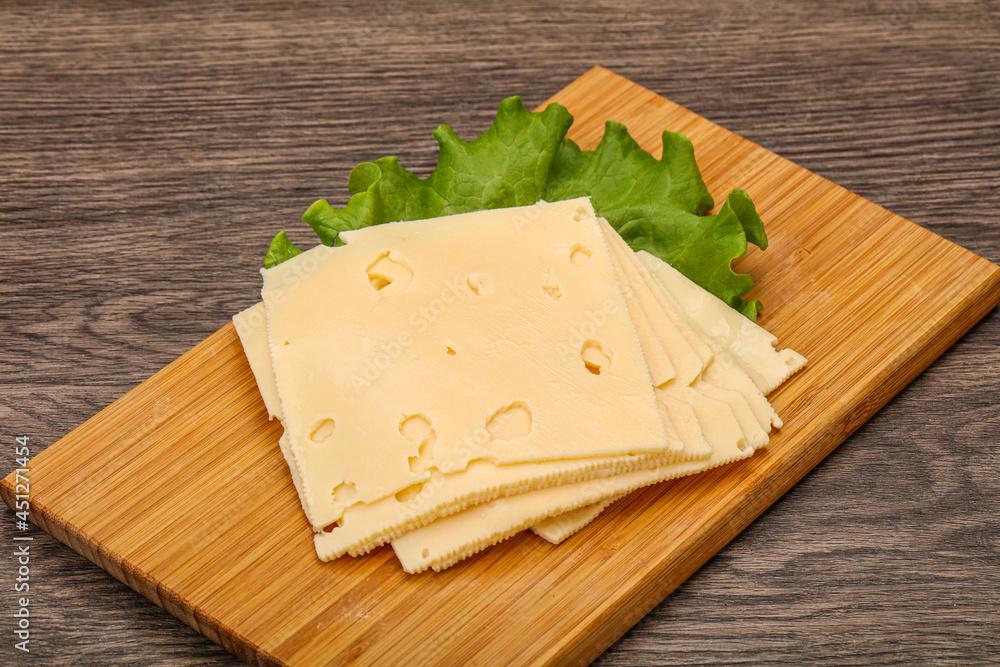 Sliced yellow cheese over board Sliced yellow cheese over board