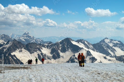 Climbers are walking along a mountain range.