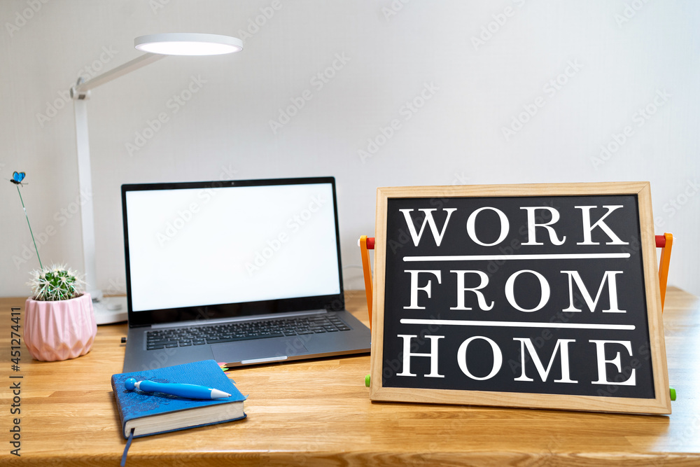 Working from home remote work inspirational social media lightbox message board next to laptop and sketchpad for COVID-19 quarantine closure of all businesses. Working from home remote work inspirational social media lightbox message board next to laptop and sketchpad for COVID-19 quarantine closure of all businesses.