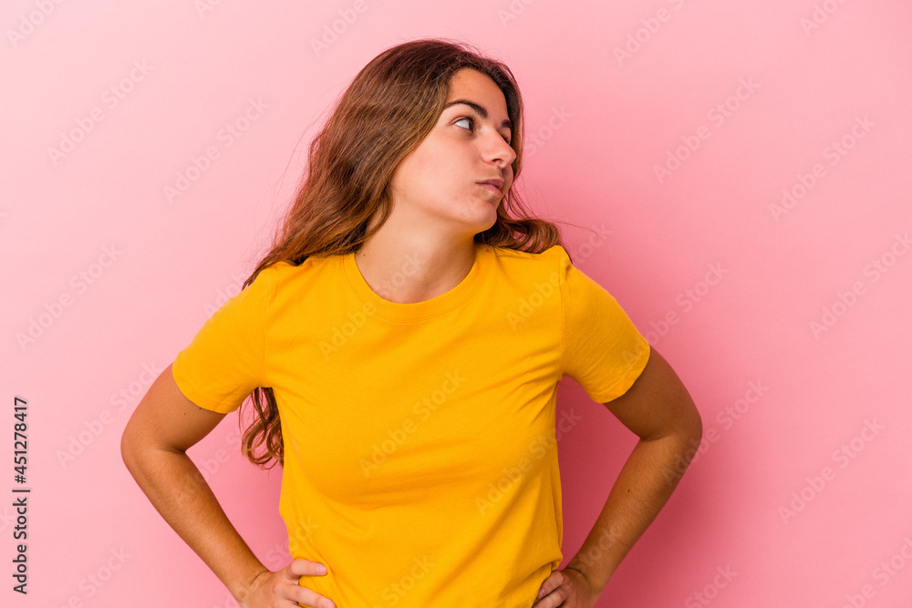 Young caucasian woman isolated on pink background dreaming of achieving goals and purposes Young caucasian woman isolated on pink background dreaming of achieving goals and purposes