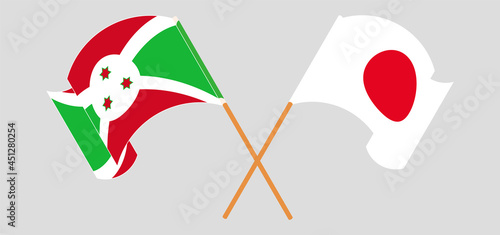 Crossed and waving flags of Burundi and Japan