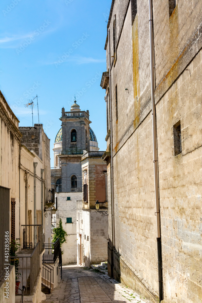 Medieval Street in the centre of the town of Oria, in the South of Italy and Belltower on the Background