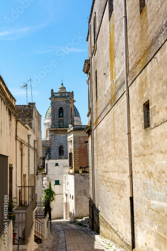 Medieval Street in the centre of the town of Oria  in the South of Italy and Belltower on the Background