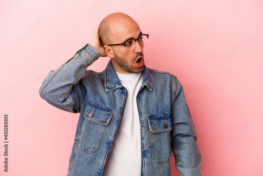 Fototapeta premium Young caucasian bald man isolated on pink background being shocked, she has remembered important meeting.