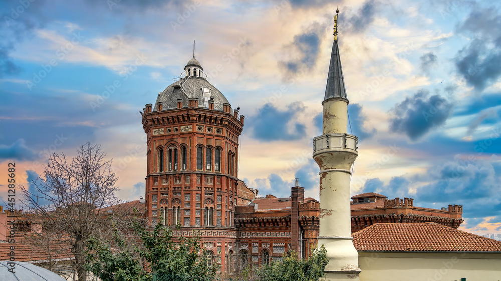Istanbul, Turkey - March 2018: Exterior view of the Phanar Greek Orthodox College, Ozel Fener Rum Lisesi, Fener neighborhood in Fatih district with a minaret of a nearby mosque Istanbul, Turkey - March 2018: Exterior view of the Phanar Greek Orthodox College, Ozel Fener Rum Lisesi, Fener neighborhood in Fatih district with a minaret of a nearby mosque