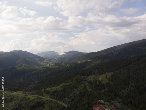 Aerial shot from drone on foggy summer morning in the mountains. Carpathian, Ukraine, Europe