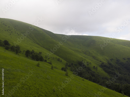 Aerial shot from drone on foggy summer morning in the mountains. Carpathian, Ukraine, Europe