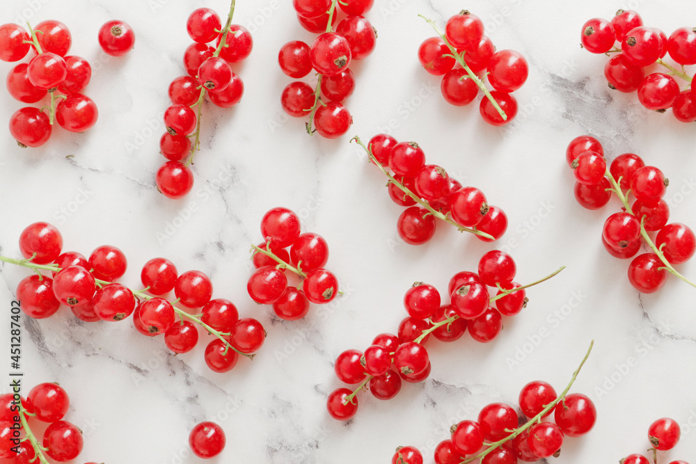 composition of ripe red currant berries on a textured marble background composition of ripe red currant berries on a textured marble background