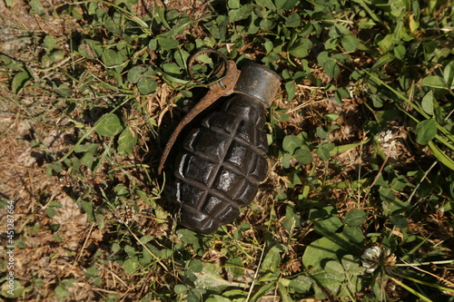 Vintage rusty Polish hand grenade on the ground