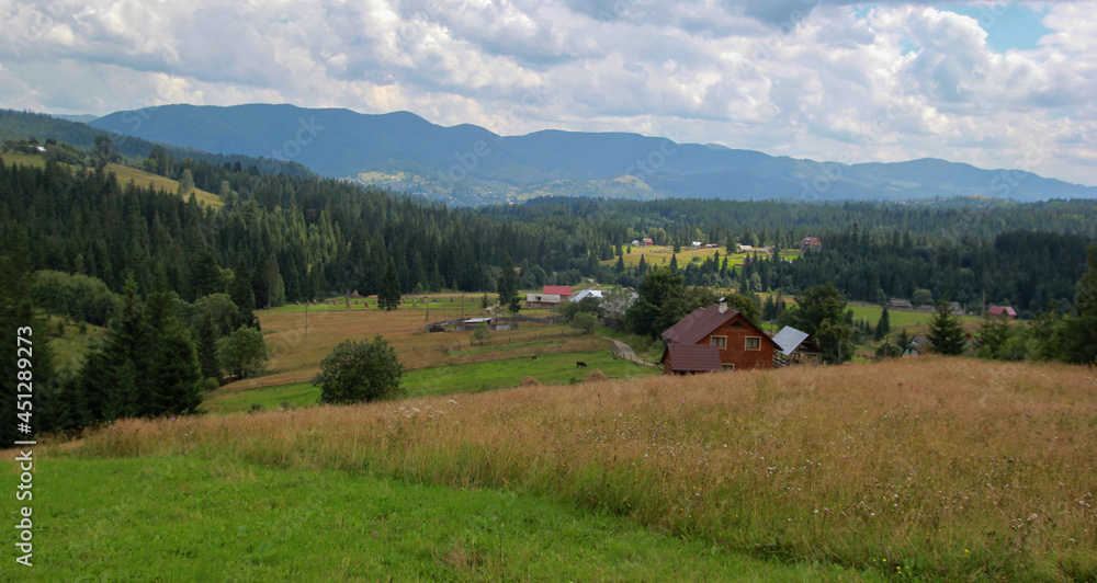 View of the Carpathians, forest, mountains, clouds and village View of the Carpathians, forest, mountains, clouds and village