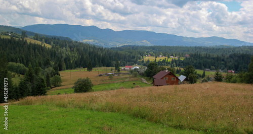 View of the Carpathians, forest, mountains, clouds and village