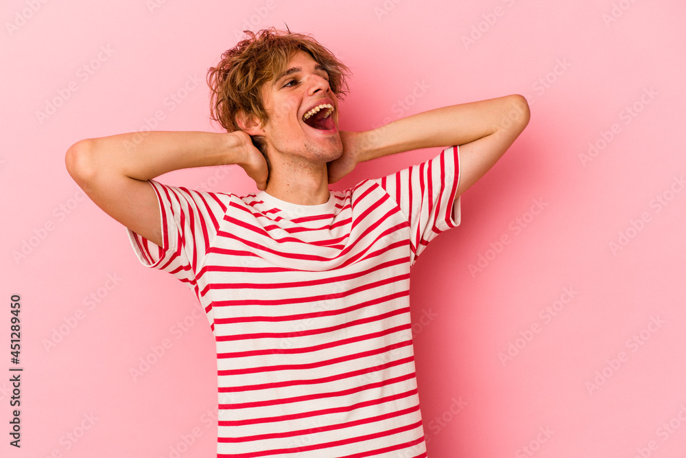 Young caucasian man with make up isolated on pink background feeling confident, with hands behind the head. Young caucasian man with make up isolated on pink background feeling confident, with hands behind the head.