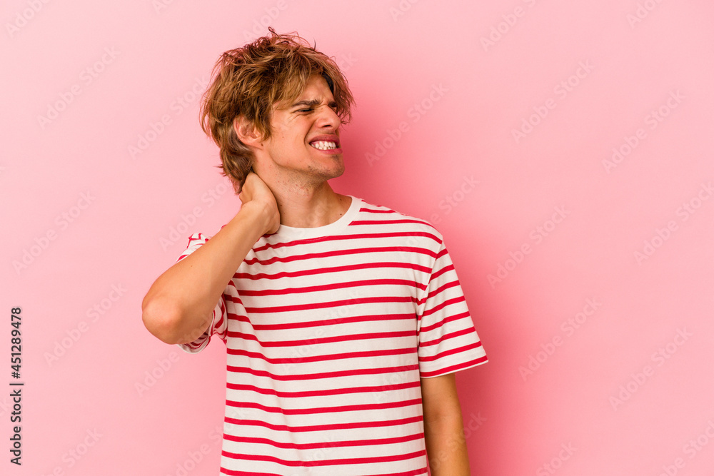 Young caucasian man with make up isolated on pink background suffering neck pain due to sedentary lifestyle. Young caucasian man with make up isolated on pink background suffering neck pain due to sedentary lifestyle.