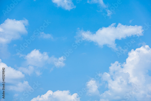 Blue sky with fluffy cumulus clouds floating in summer day. Pure white soft cloudscape scene, beautiful abstract in the air. Cloudy space view background. Tranquil environment, nature outdoor.