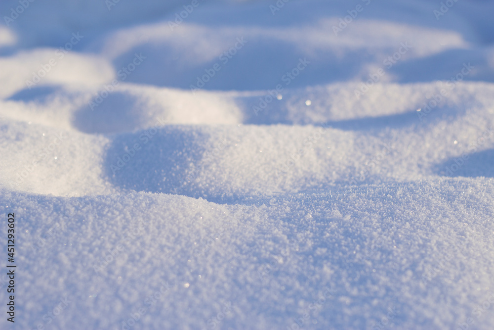 Snow drifts in frosty and sunny winter day. Snow surface background.