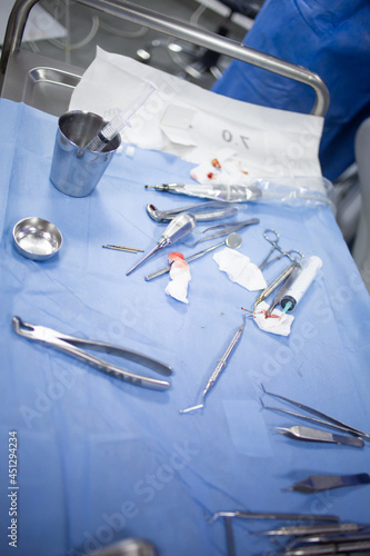 Medical tray table with dental tools and equipment during teeth surgery.