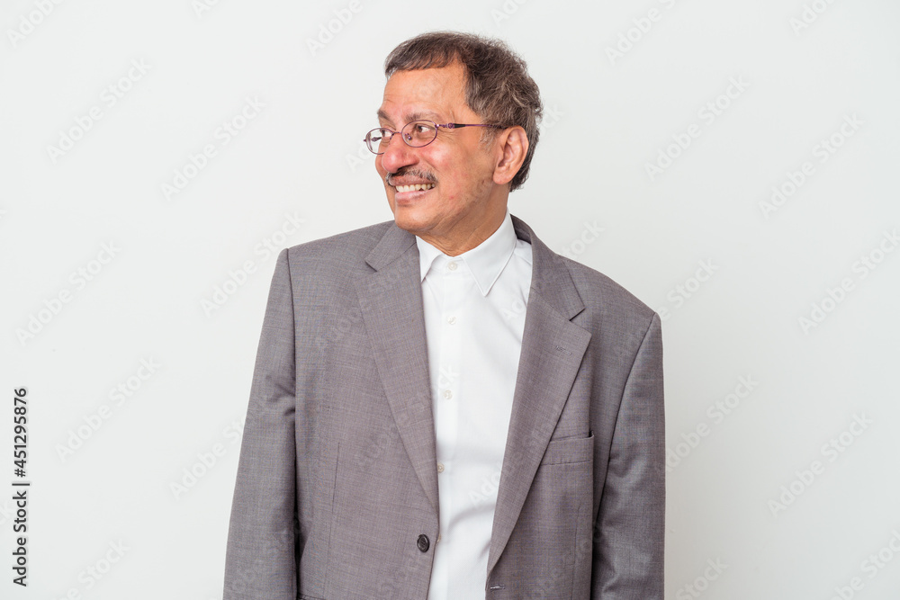 Middle aged indian business man isolated on white background looks aside smiling, cheerful and pleasant. Middle aged indian business man isolated on white background looks aside smiling, cheerful and pleasant.