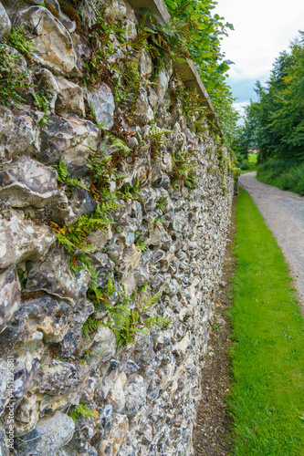 Old stone wall of the Manor Farm in a small village of Huish on the South facing edge of the Marlborough Downs, adjacent to Pewsey Vale, Wiltshire photo