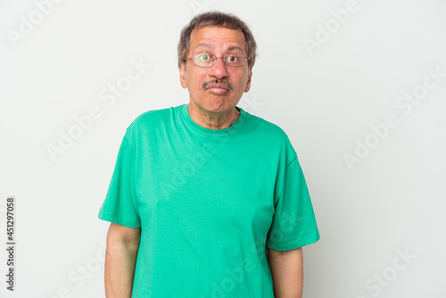 Middle aged indian man isolated on white background sad, serious face, feeling miserable and displeased.