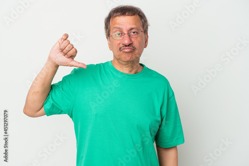 Middle aged indian man isolated on white background showing a dislike gesture, thumbs down. Disagreement concept. © Asier