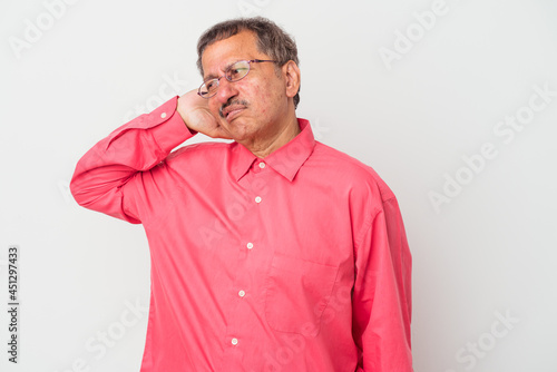 Middle aged indian man isolated on white background tired and very sleepy keeping hand on head. © Asier
