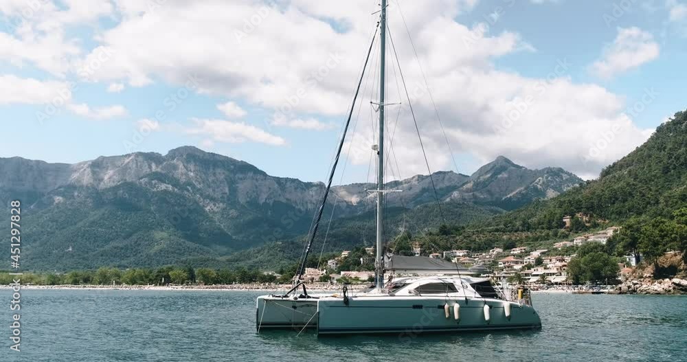Luxury sail catamaran yacht moored in the sea, luxury maritime travel. Luxury sail catamaran yacht moored in the sea, luxury maritime travel.