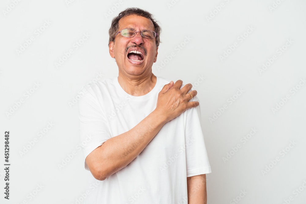 Middle aged indian man isolated on white background having a shoulder pain. Middle aged indian man isolated on white background having a shoulder pain.