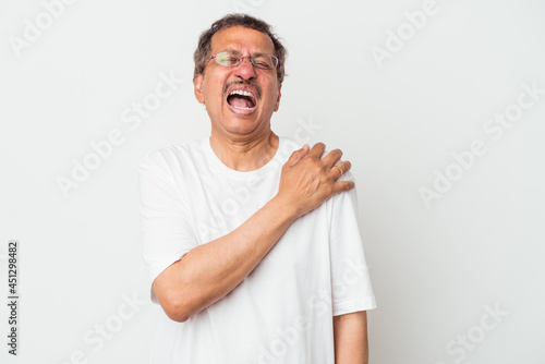 Middle aged indian man isolated on white background having a shoulder pain.