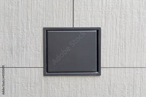 A dark metal plaque on a stone wall. Copy space