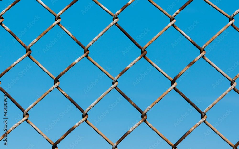 Fototapeta premium chainlink fence on blue sky